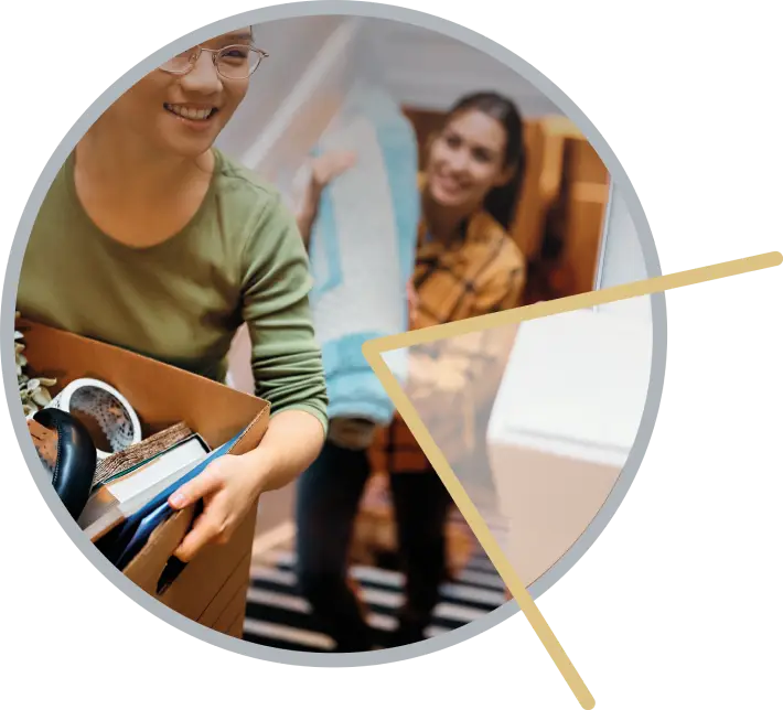 Happy women moving boxes and belongings into their new home, representing a fresh start.